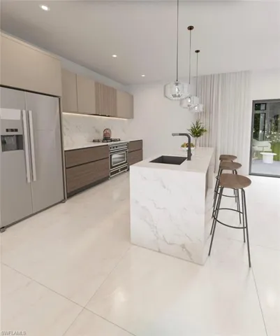 Kitchen featuring a waterfall island with an integrated sink, pendant lighting, stainless steel appliances, and large format floor tile