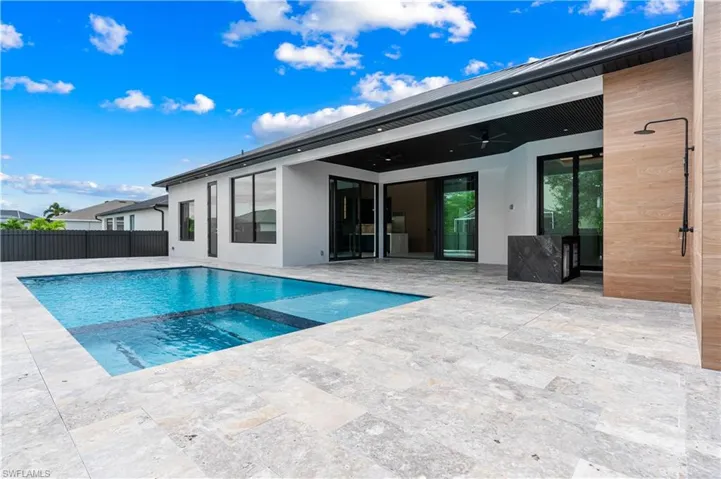View of swimming pool featuring a patio, a ceiling fan, and a pool with connected hot tub