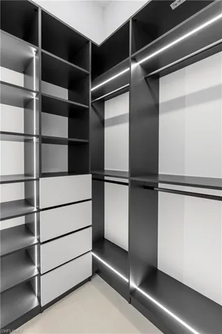 Walk in closet with light tile patterned floors