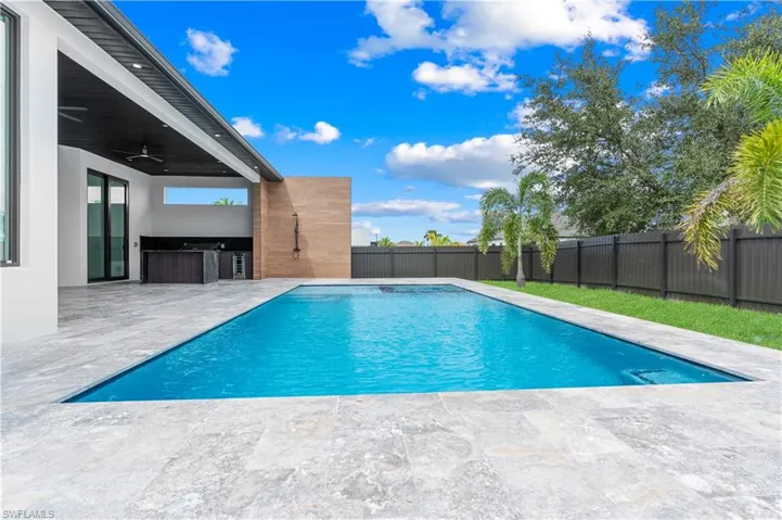 View of pool featuring area for grilling, a patio area, and a fenced backyard