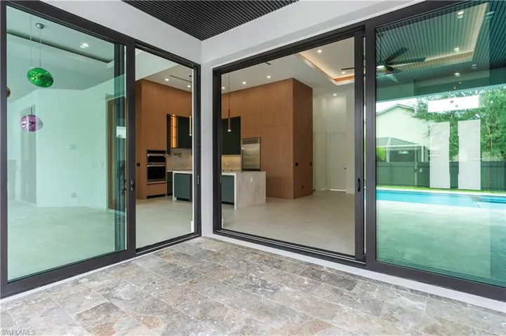 Property entrance featuring a patio and a pool