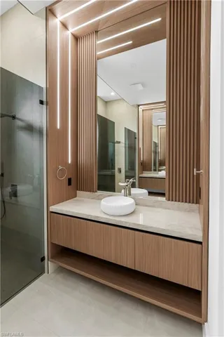 Bathroom with a stall shower, vanity, and light tile patterned floors