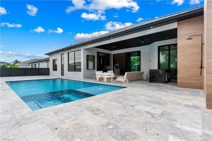 View of pool with a patio, a pool with connected hot tub, and a ceiling fan