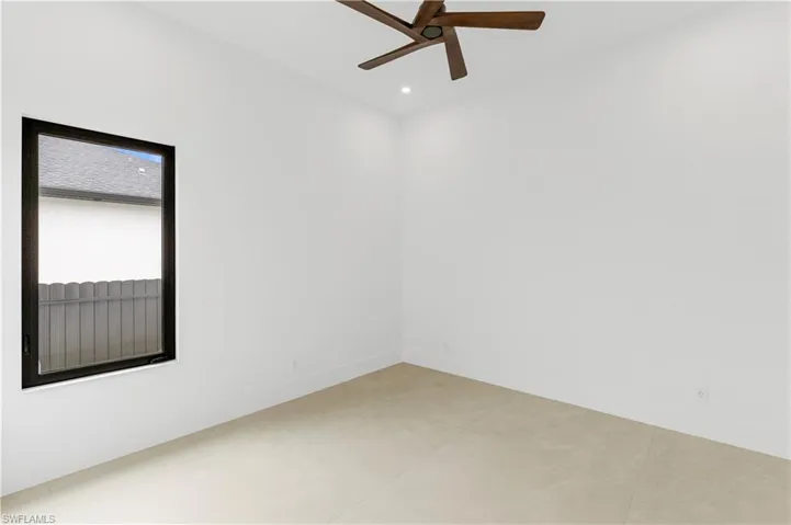 Empty room with a ceiling fan and recessed lighting