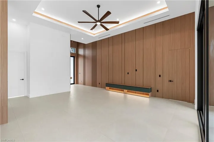 Full bathroom with a freestanding bath, a shower stall, vanity, and light tile patterned floors