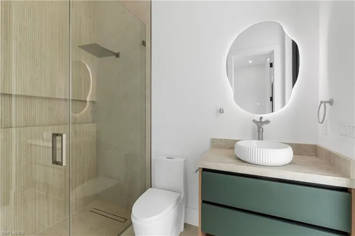 Bathroom with a stall shower and vanity