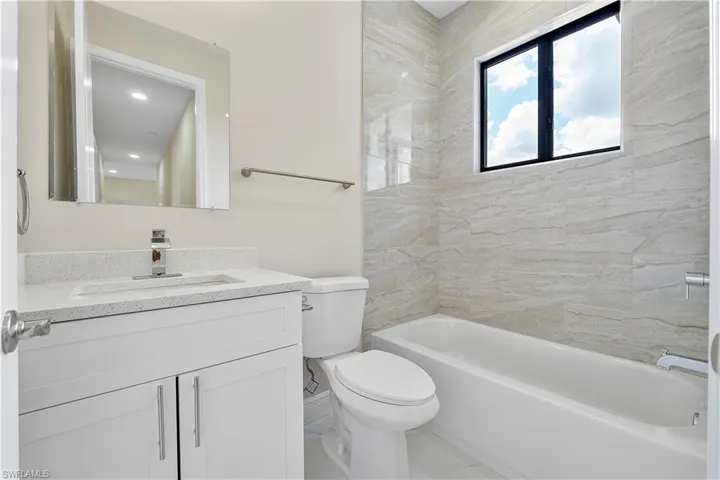Full bathroom with vanity and bathing tub / shower combination