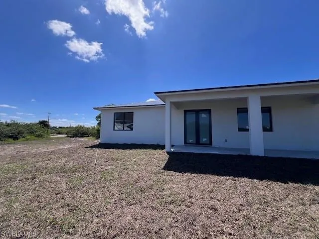 Back of house featuring stucco siding and a patio