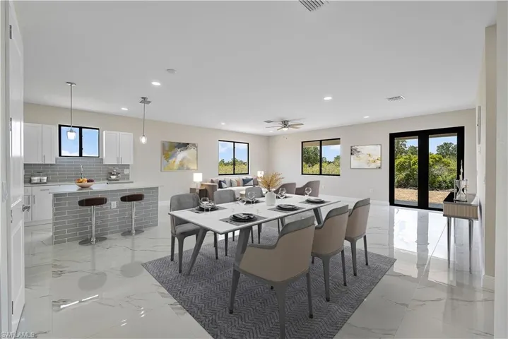 Dining area featuring recessed lighting, french doors, and light marble finish floors