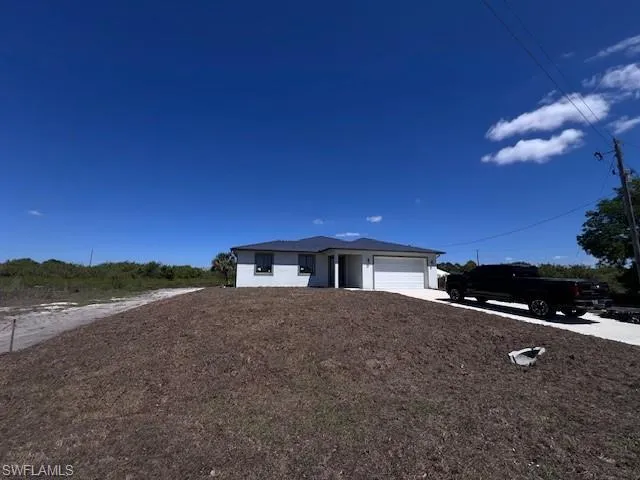 View of front of house featuring driveway and a garage
