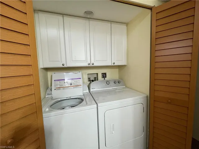 Laundry room featuring cabinet space and washer and clothes dryer