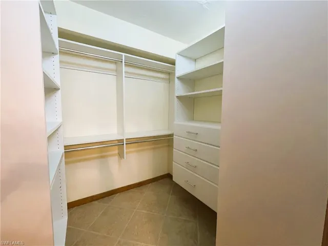 Spacious closet with light tile patterned flooring