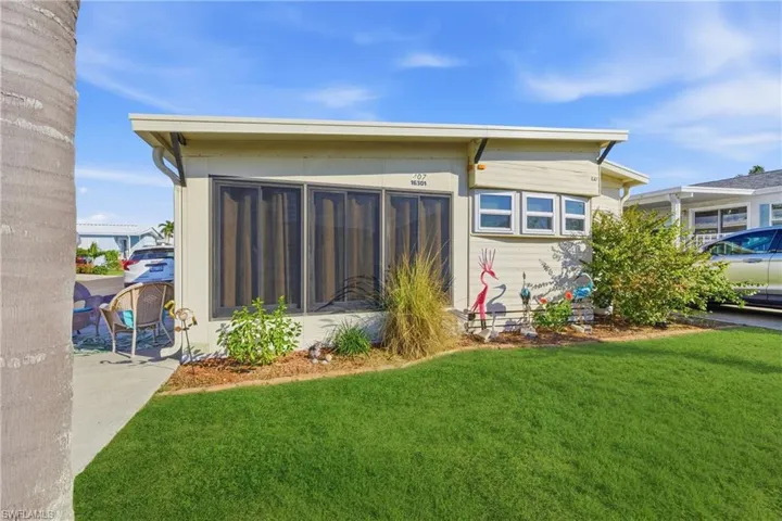 Back of property featuring a lawn
