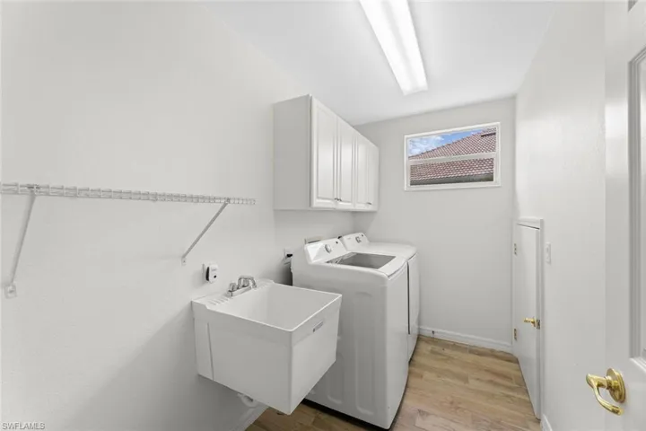 Dedicated laundry room with utility tub