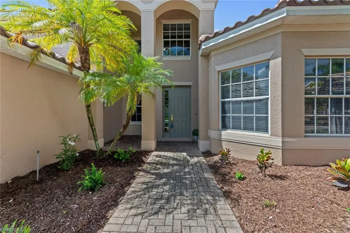 View of entrance to property with freshly painted front door and refreshed landscaping!