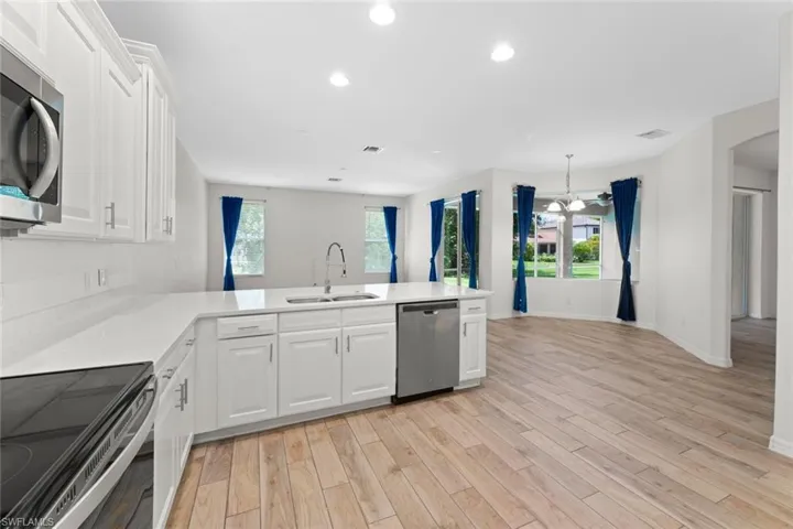 Kitchen featuring white cabinetry, and stainless steel appliances