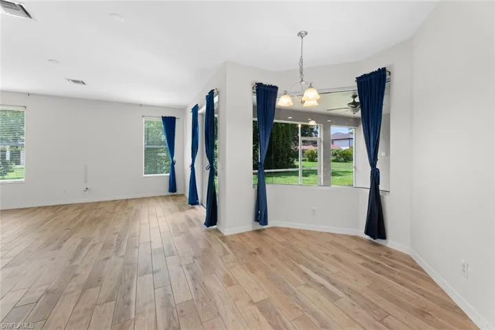 Kitchen nook featuring a seamless bay window looking out onto the yard