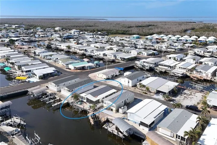 Aerial perspective of suburban area featuring a large body of water