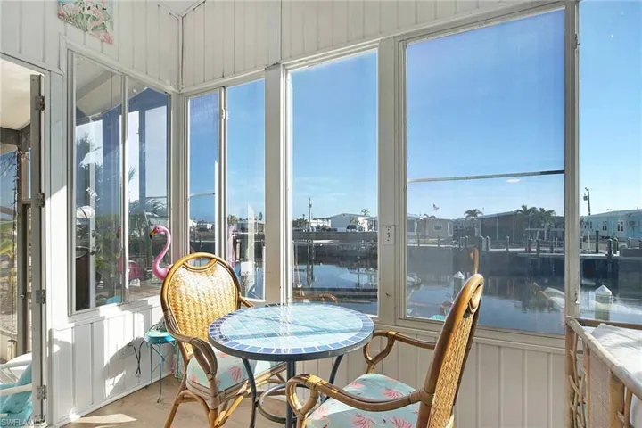 Sunroom / solarium with a water view