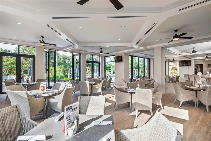 Dining space with coffered ceiling, beamed ceiling, a ceiling fan, wood finished floors, and recessed lighting