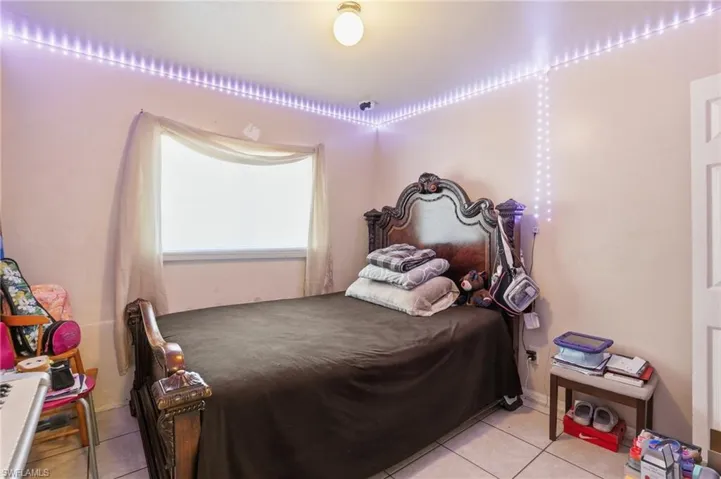 Bedroom with light tile patterned flooring