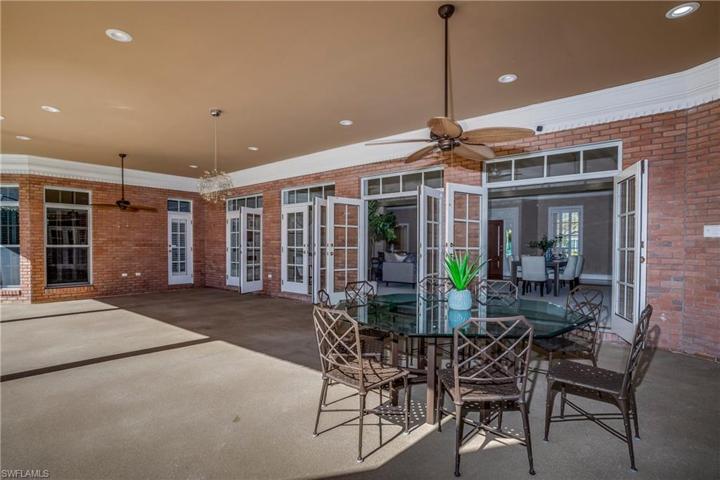 Large covered patio with large eating area and electric sun shades