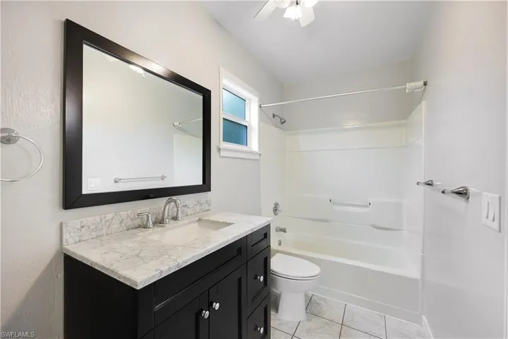 Full bathroom with doors leading to 1st and 2nd rooms on main level