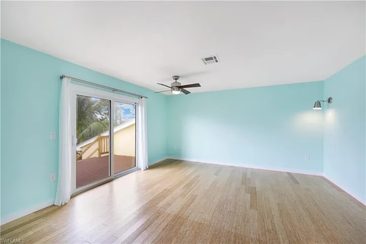 Upstairs primary bedroom with entrance to patio