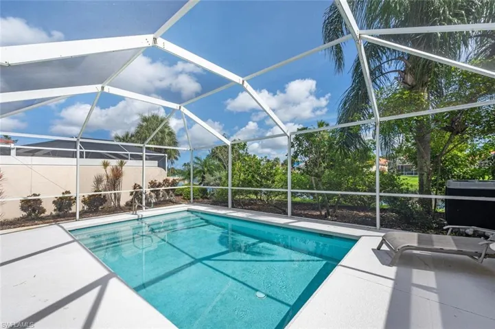 View of pool with a patio and a lanai