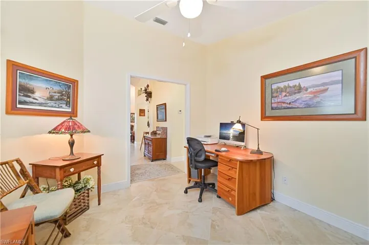 Office space featuring ceiling fan and baseboards