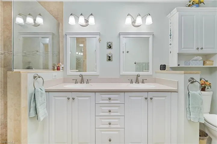 Bathroom featuring double vanity and a walk in shower