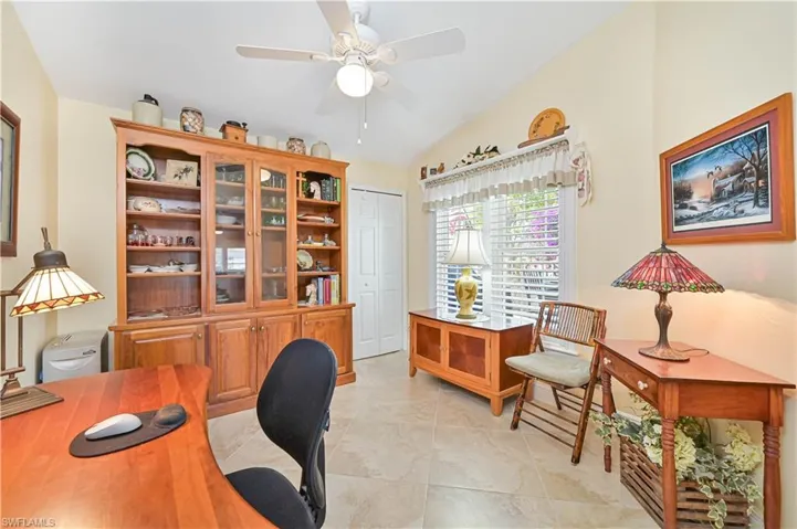 Office with ceiling fan and lofted ceiling