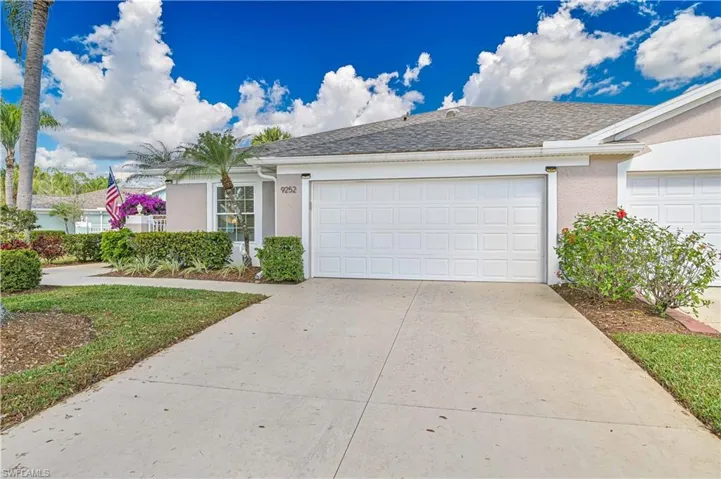 Ranch-style house with stucco siding, driveway, an attached garage, and roof with shingles