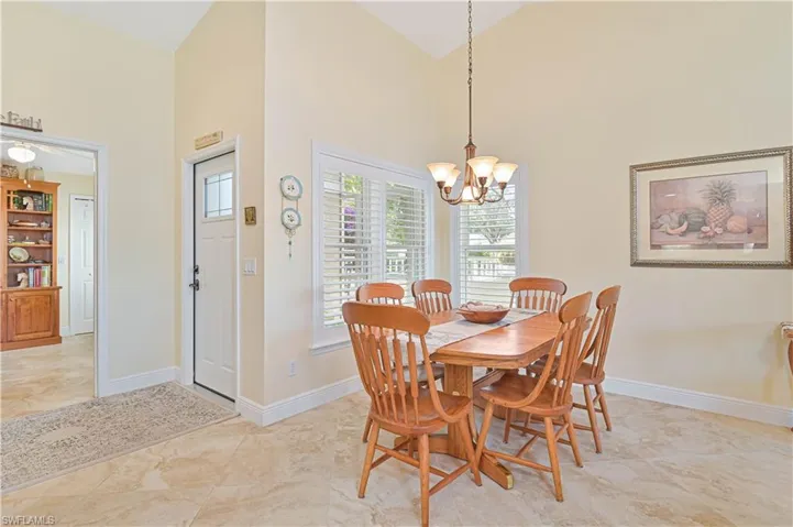 Dining area with a chandelier and vaulted ceiling