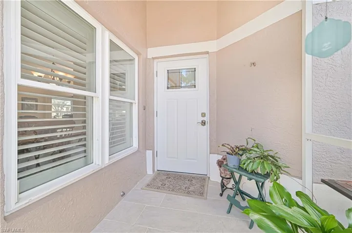 Entrance to property with stucco siding