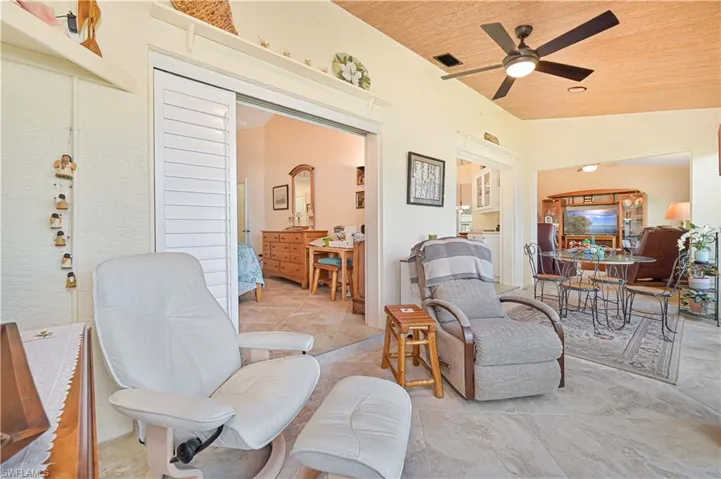 Living area featuring ceiling fan and wooden ceiling