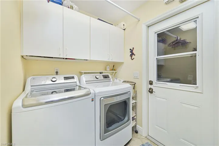 Laundry room with washing machine and clothes dryer and cabinet space