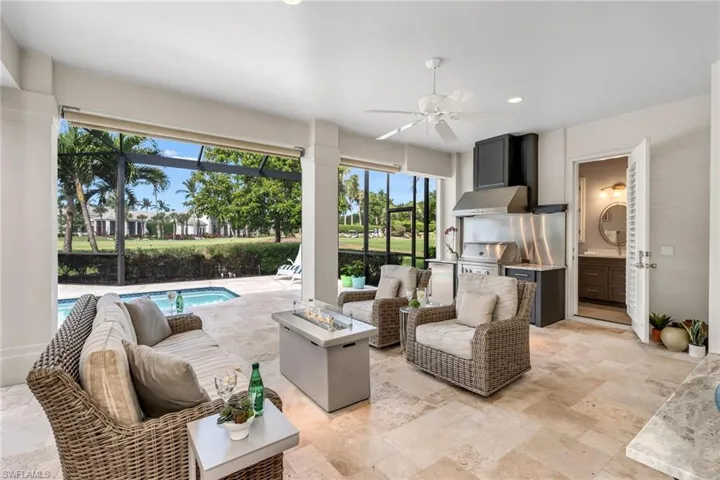 The entire lanai has a redesigned pool, spa, and outdoor kitchen, with Lynx grill, Thermador hood, stainless steel backsplash and refrigerator.