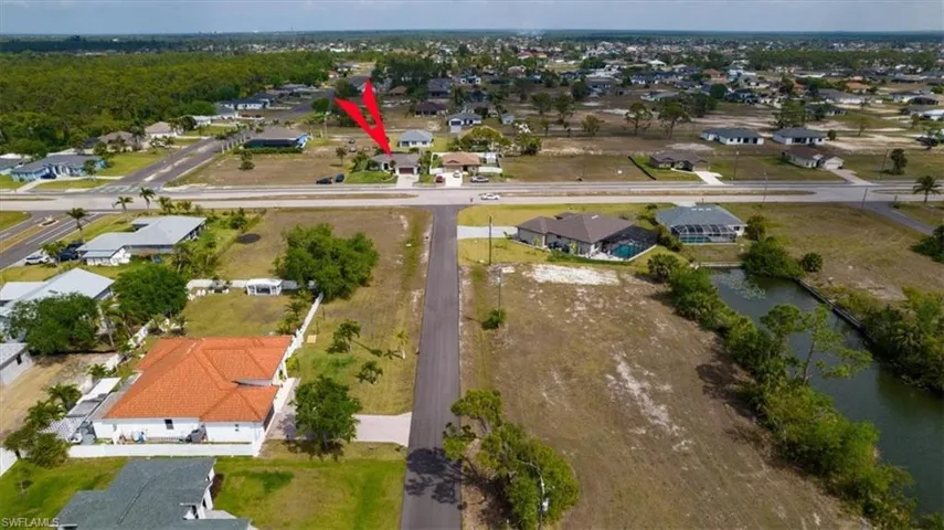Aerial view of property's location featuring nearby suburban area
