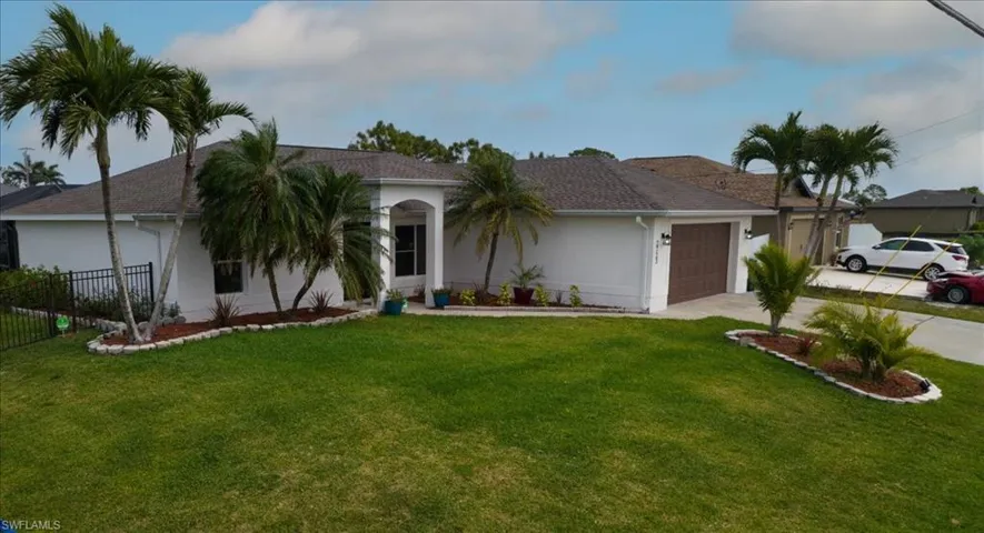 Ranch-style home featuring stucco siding, driveway, and an attached garage