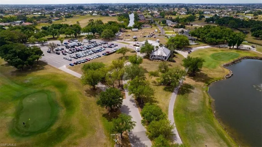 Aerial view of property and surrounding area featuring a golf course