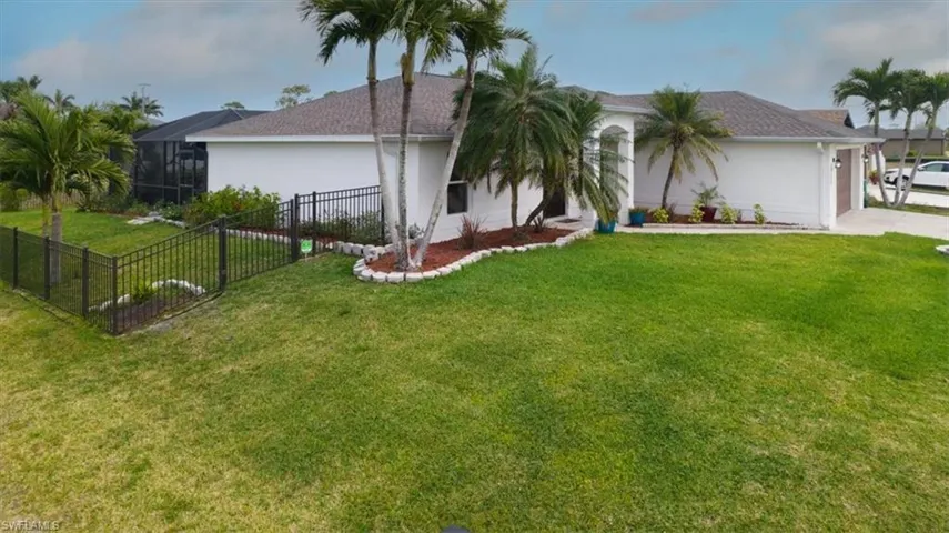 View of side of property with stucco siding, a lanai, driveway, and roof with shingles