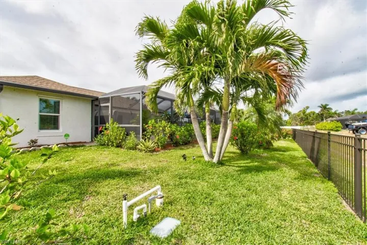 View of yard with glass enclosure and a sunroom
