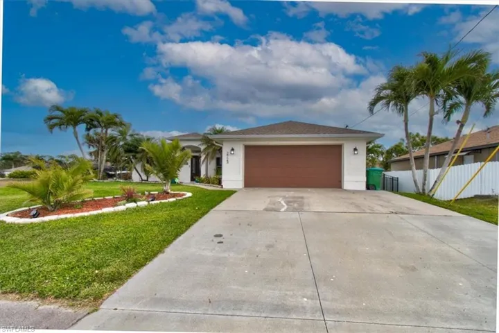 Single story home featuring stucco siding, concrete driveway, and an attached garage