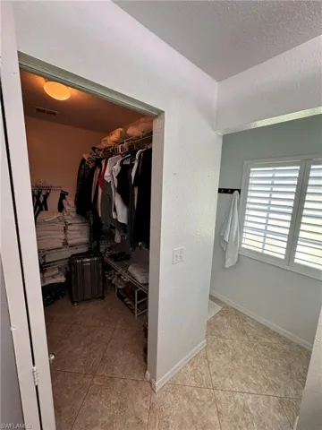 Spacious closet featuring light tile patterned floors
