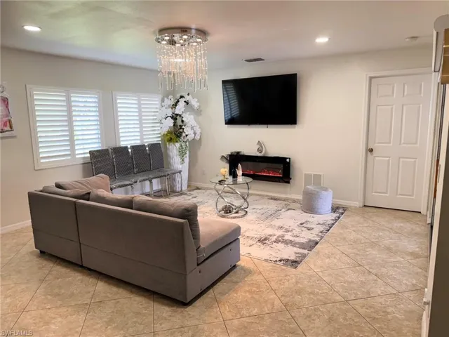 Tiled living room featuring an inviting chandelier