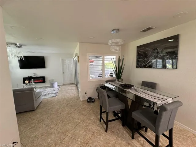 Dining area with light tile patterned flooring