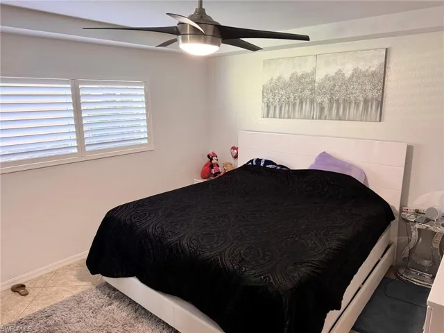 Tiled bedroom with ceiling fan