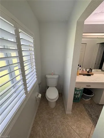 Bathroom with vanity, tile patterned flooring, and toilet