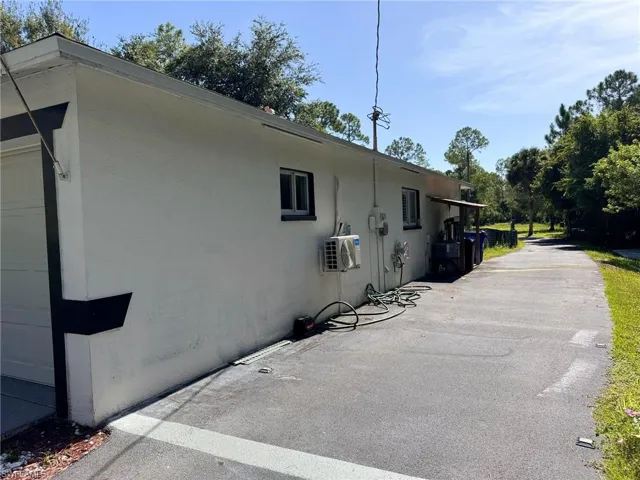 View of property exterior featuring a garage